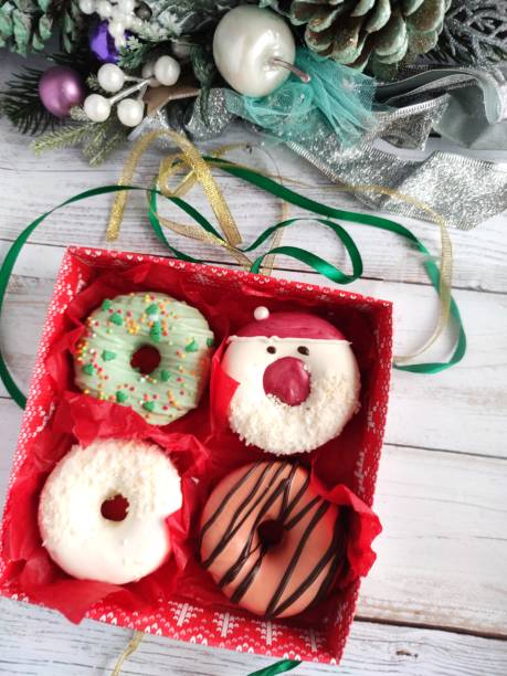 istock christmas donut box, donuts with icing and sprinkles 1360546048