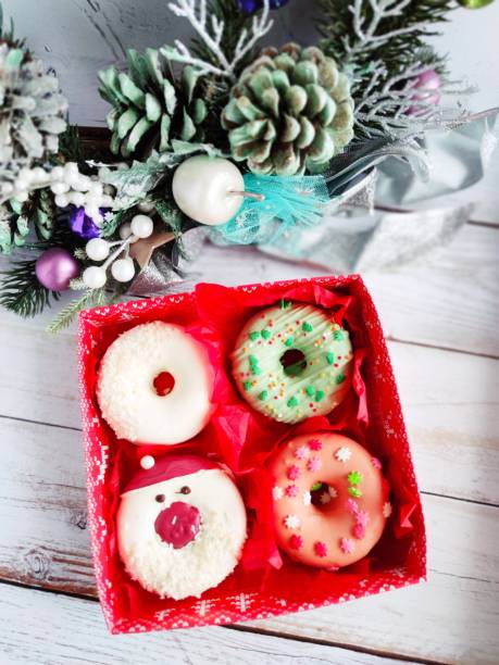 istock christmas donut box, donuts with icing and sprinkles 1360546077
