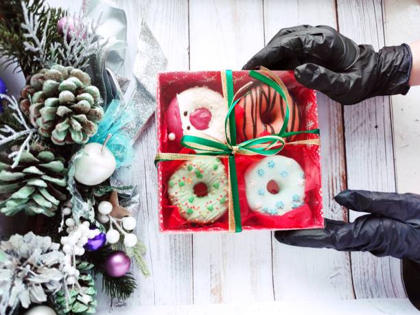 istock christmas donut box, donuts with icing and sprinkles 1360546123