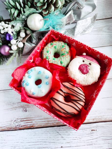 istock christmas donut box, donuts with icing and sprinkles 1360546184