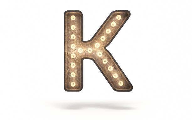Letter K decorated with light bulb covered with concrete