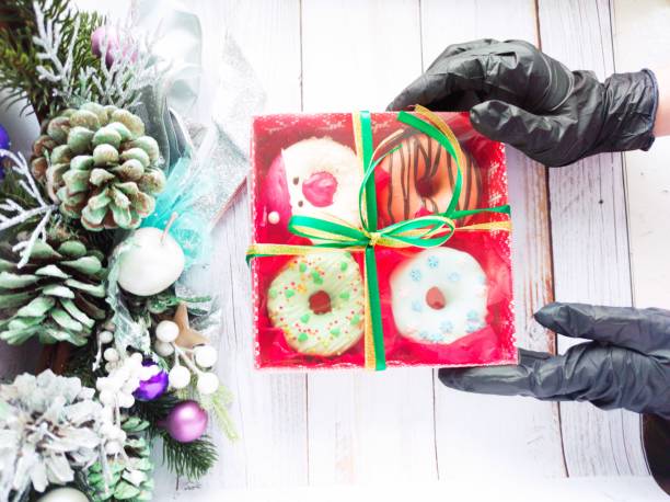 istock christmas donut box, donuts with icing and sprinkles 1360546272