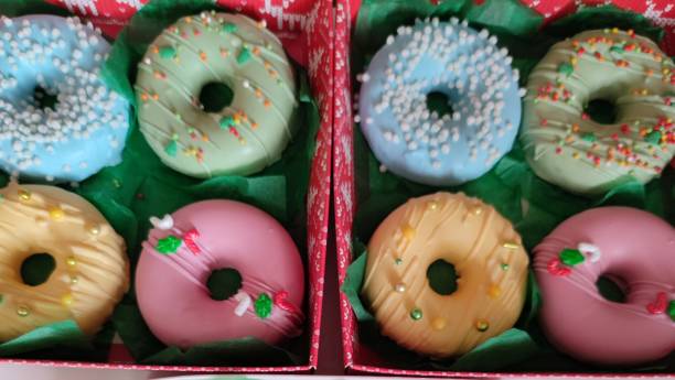 istock christmas donut box, donuts with icing and sprinkles 1360547287