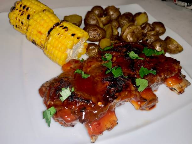 istock Grilled ribs with potatoes and corns 1360547296