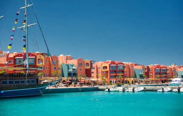 panoramic seascape on colorful Marina promenade street from Red Sea with moored motor yachts. Marina, Hurghada, Egypt
