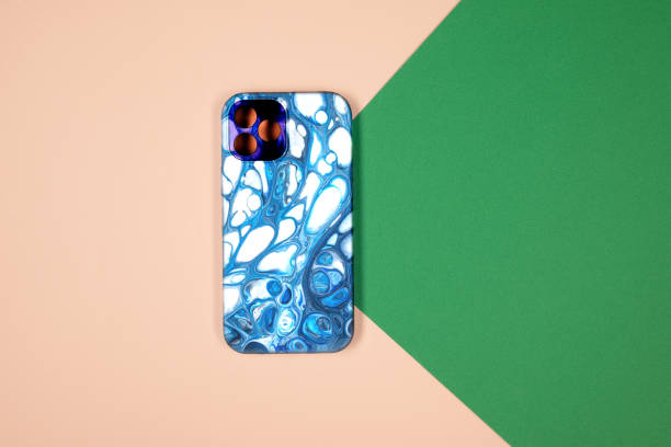 istock blue phone case back view. Template of iphone 12 plus case. Green and beige background 1360547671