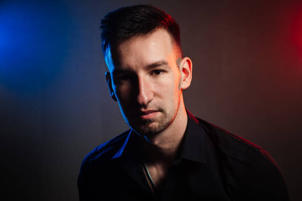 istock handsome man portrait with colored reflexes. color filters 1360548788