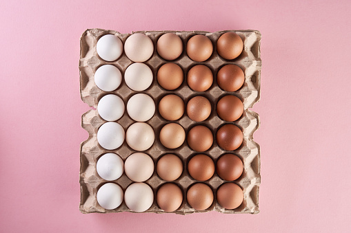 Chicken eggs of natural shades and colors on egg tray