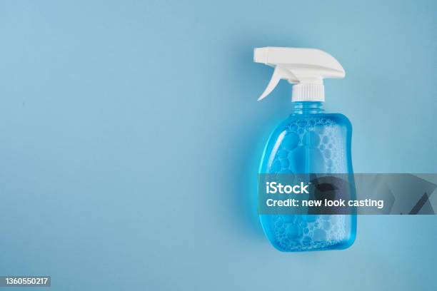 Detergent Cleaner Spray Bottle Isolated On Blue Background Stock Photo - Download Image Now