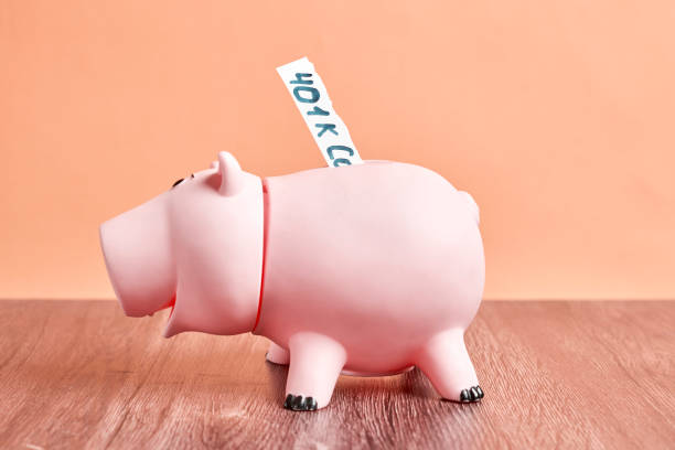 istock Pink piggy bank with 401k text 1360551494