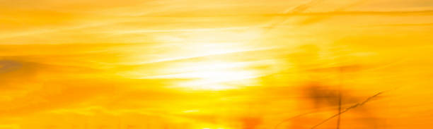 istock Clouds in a yellow sky in bright sunlight at sunrise in winter 1360551916
