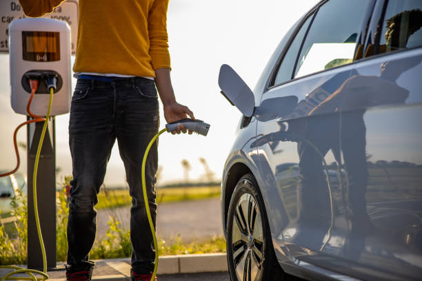istock African american man inserting plug into the electric car charging socket 1360553047