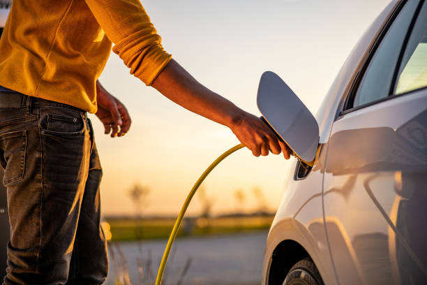 istock African american man inserting plug into the electric car charging socket 1360553194