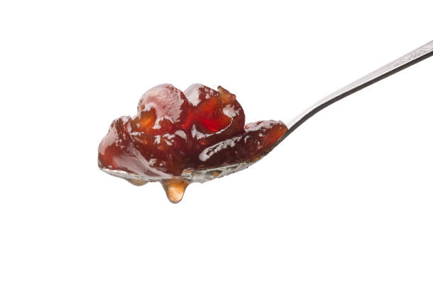 spoonful of wood apple jam isolated on white background, closeup