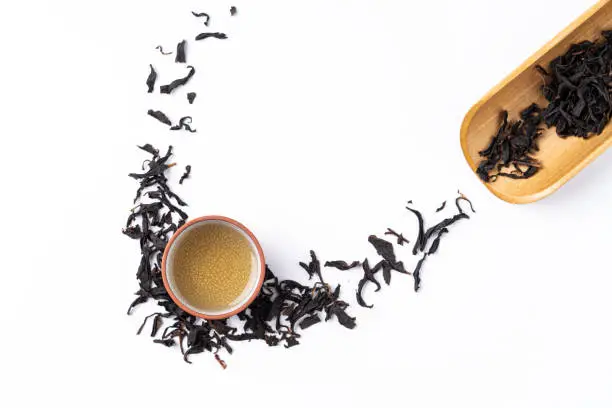 Top view of fresh black tea with kettle teapot and leaves in Taiwan, Asian culture design concept layout.