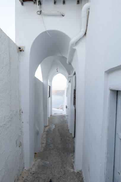 istock Small alley in Santorini under an arch, Greece 1360553987