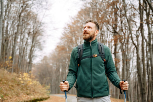 istock Active tourist hiking in the autumn forest 1360554170