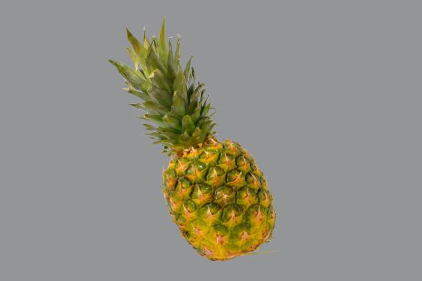 istock Pineapple on a color background. Clipping path. Golden ripe pineapple fruit on a color background. Healthy nutrition 1360555277