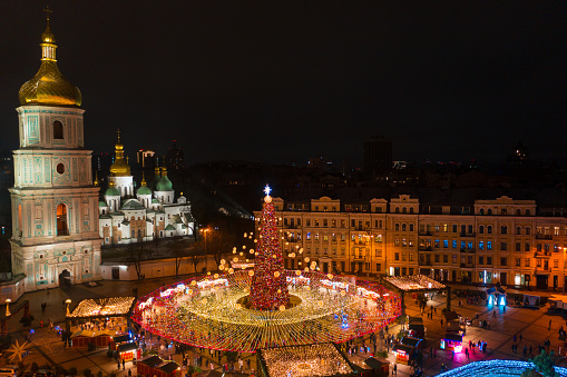 KYIV, UKRAINE  DECEMBER 18, 2021 Aerial view in Ukraine's main Christmas tree is situated in Sofiiska Square near Saint Sophia Cathedral, Kyiv, capital of Ukraine. The 102ft high tree is decorated with 20,000 golden and red baubles and 10km-long string lights that form a canopy