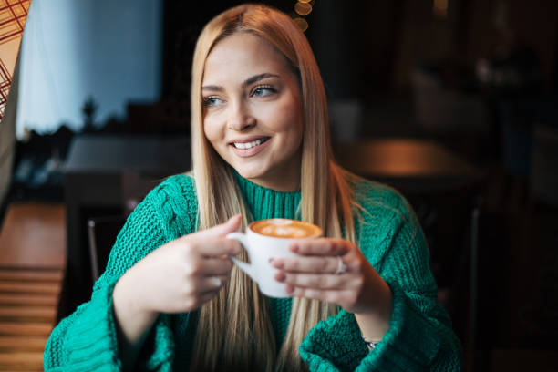 istock Pretty blonde woman in a cafe. 1360558428