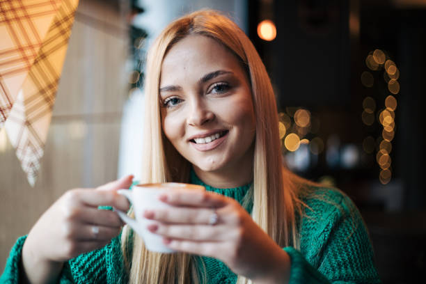Pretty blonde woman in a cafe.