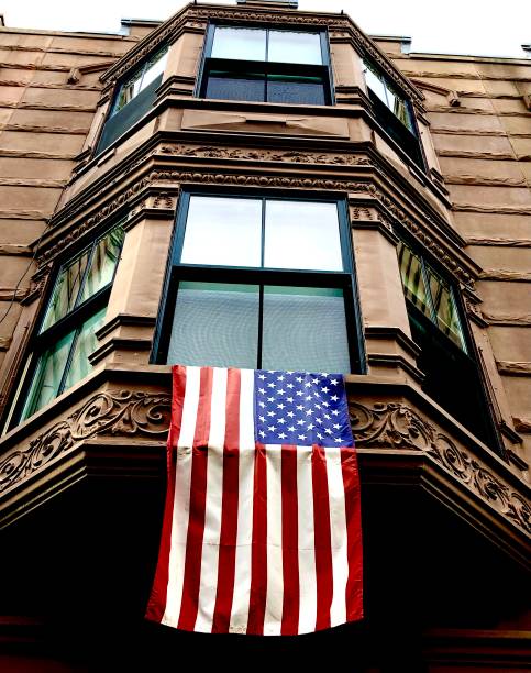 istock American Flag on Brownstone 1360560210