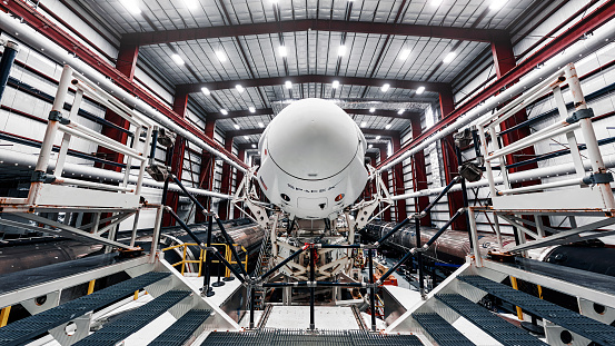 Space launch preparation. Spaceship SpaceX Crew Dragon, atop the Falcon 9 rocket, inside the hangar , just before rollout to the launchpad. Elements of this image furnished by NASA.
