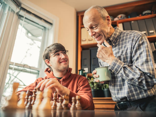 istock Grandfather and Grandson playing chess at home 1360565294