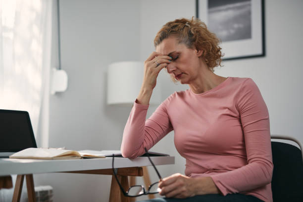 istock Woman with eyes hurting, sinus problem, headache, head pain, working from home troubles and issues. 1360567132