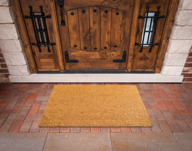 istock Blank Welcome Mat At Custom Front Door of House. 1360568111