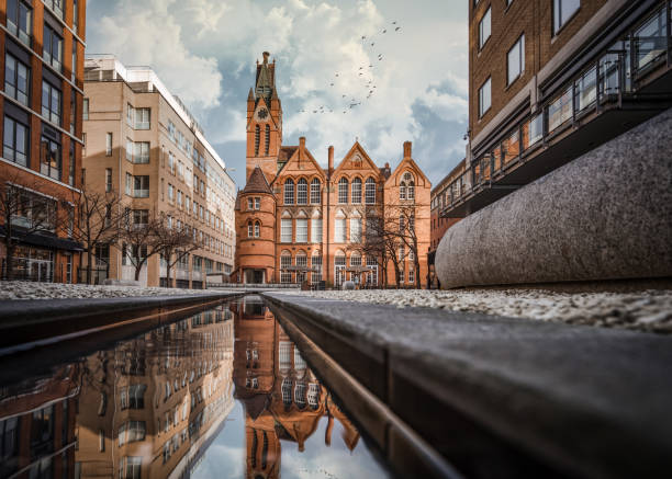 Brindley Place red brick church building reflected in water Brindley Place red brick church building reflected in water. West Midlands landmark buildings redevelopment in historic city centre reflection in stream. Birds and clouds in sky. west midlands photos stock pictures, royalty-free photos & images
