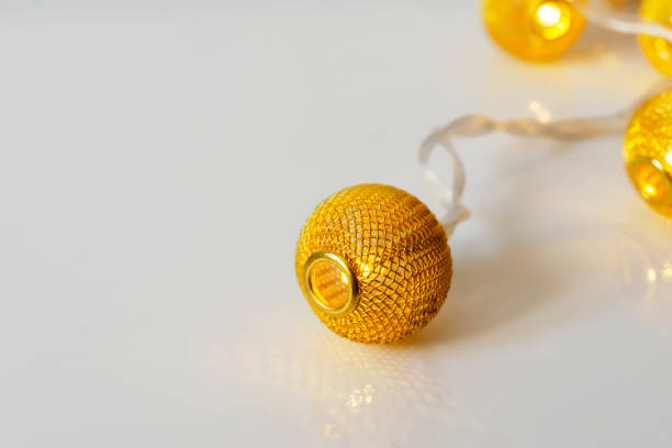istock white background with golden wire christmas light 1360571262