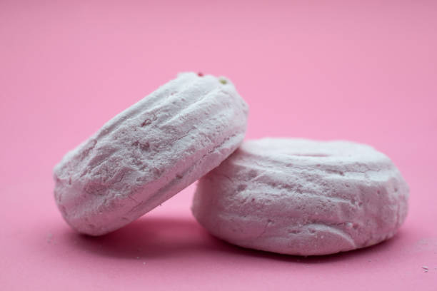 istock meringues on pink background 1360571465