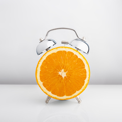 alarm clock orange on a white background. Isolate