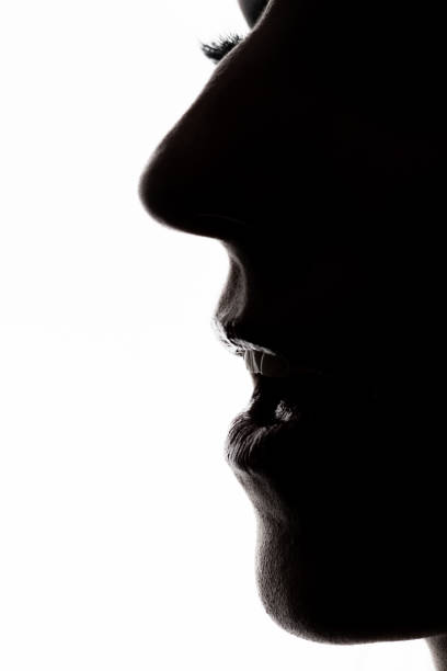 istock Womans face dark profile silhouette in white background 1360575950