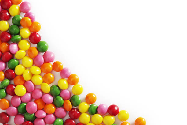 Colorful sweet candy on a white background, top view with copy space
