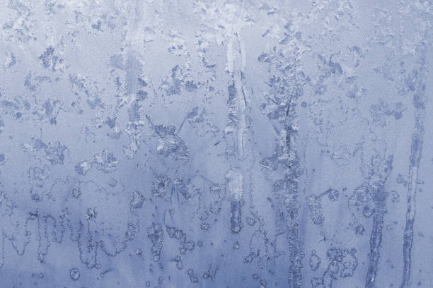 istock Ice on a window with snowflakes 1360577463