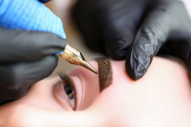 istock Beauty masters hands do permanent eyebrow makeup 1360577615
