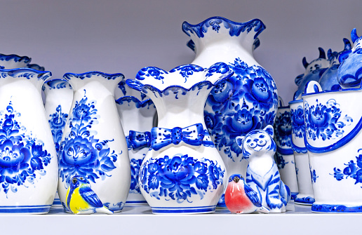 Porcelain utensil with blue floral patterns in the Russian style - gzhel. Traditional russian souvenir.