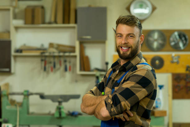 istock Portrait of smiley handsome carpenter at his workplace 1360586362