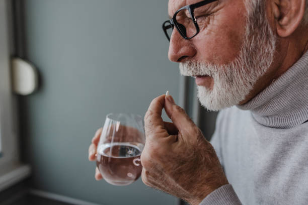 istock Senior man taking a medical pill 1360589150