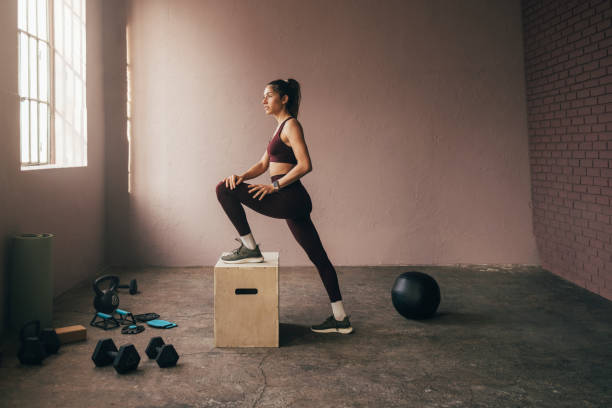 istock Beautiful Woman Exercising at Gym 1360598962