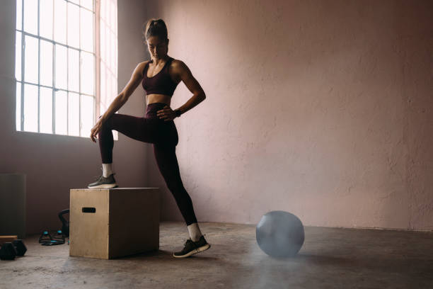 istock Beautiful Woman Exercising at Gym 1360598965
