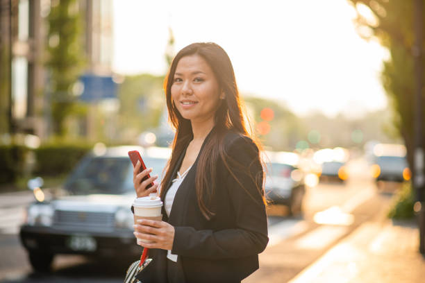 istock Attractive Asian Corporate Woman Having A Coffee 1360600189