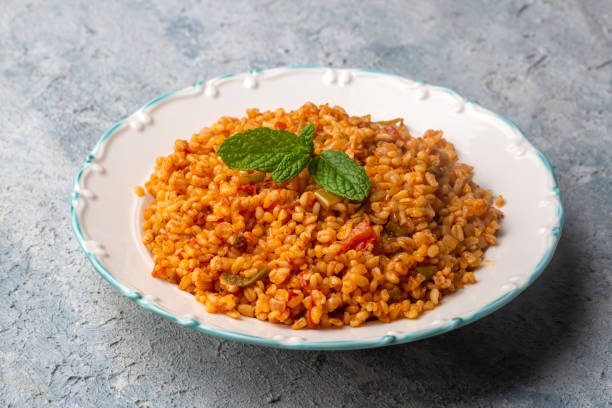 istock Traditional turkish bulgur pilaf with tomato sause in plate (Turkish name; meyhane pilavi) 1360600360