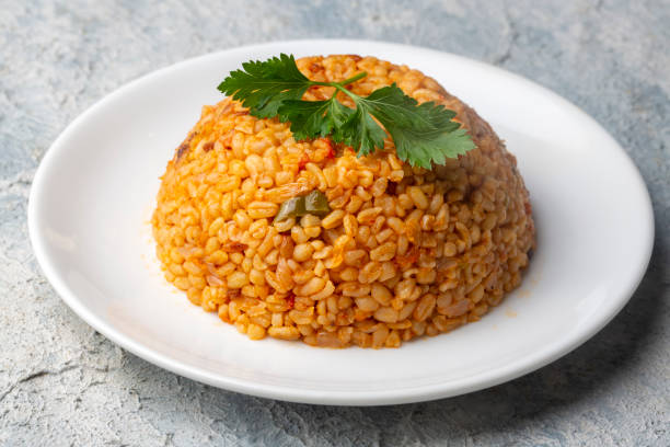 istock Traditional turkish bulgur pilaf with tomato sause in plate (Turkish name; meyhane pilavi) 1360602107