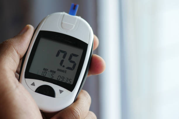 istock man's hand measuring blood sugar level at home 1360612286