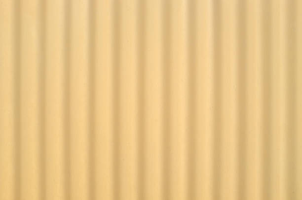 Yellow corrugated plastic wall Yellow corrugated plastic wall for background. camel colored stock pictures, royalty-free photos & images