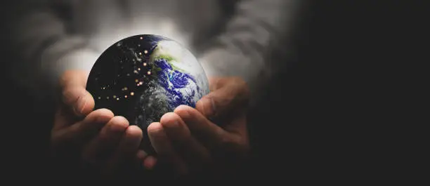 Photo of Hand hold world globe for eco environment protection and save blue planet from global warming with care business health care and technology Elements of this image furnished by NASA