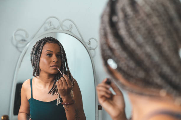 istock Afro woman making up in the studio 1360617500